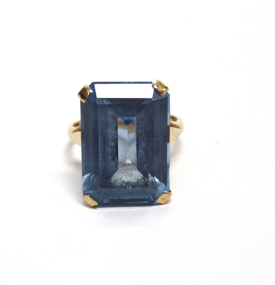 A 9CT GOLD AND BLUE SYNTHETIC SPINEL RING the rectangular step cut stone claw set on a 'D' section