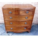 A MAHOGANY BOW FRONT CHEST OF TWO SHORT AND THREE LONG DRAWERS on turned supports, 97cm wide 54cm