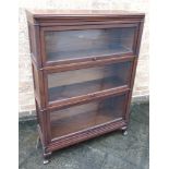 A MAHOGANY GLOBE WERNICKE STYLE THREE TIER SECTIONAL BOOKCASE by Macey, on cabriole supports, 89cm