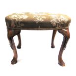 AN UPHOLSTERED OVAL STOOL on carved cabriole supports, 62cm x 46cm, 47cm high