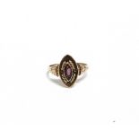 AN EARLY 20TH CENTURY ROSE GOLD AND GARNET SINGLE STONE RING the marquise-cut garnet rub-over set