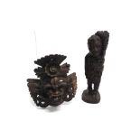 AN INDONESIAN CARVED HARDWOOD MASK 19cm high, and an African carved hardwood figure of a man