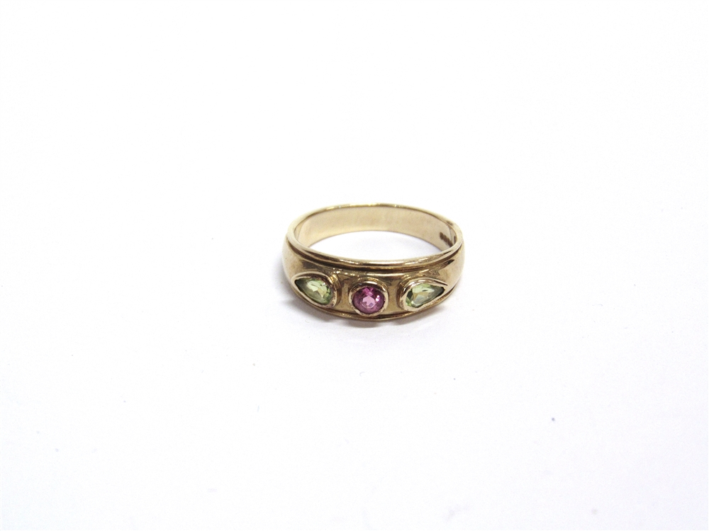 A MODERN 9CT GOLD AND TOURMALINE THREE STONE GYPSY-TYPE RING centred with a round -mixed-cut pink