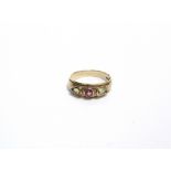 A MODERN 9CT GOLD AND TOURMALINE THREE STONE GYPSY-TYPE RING centred with a round -mixed-cut pink