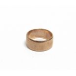 A 9CT ROSE GOLD BROAD WEDDING BAND Birmingham 1929 by M Emanuel, 9.5mm wide, size T (leading