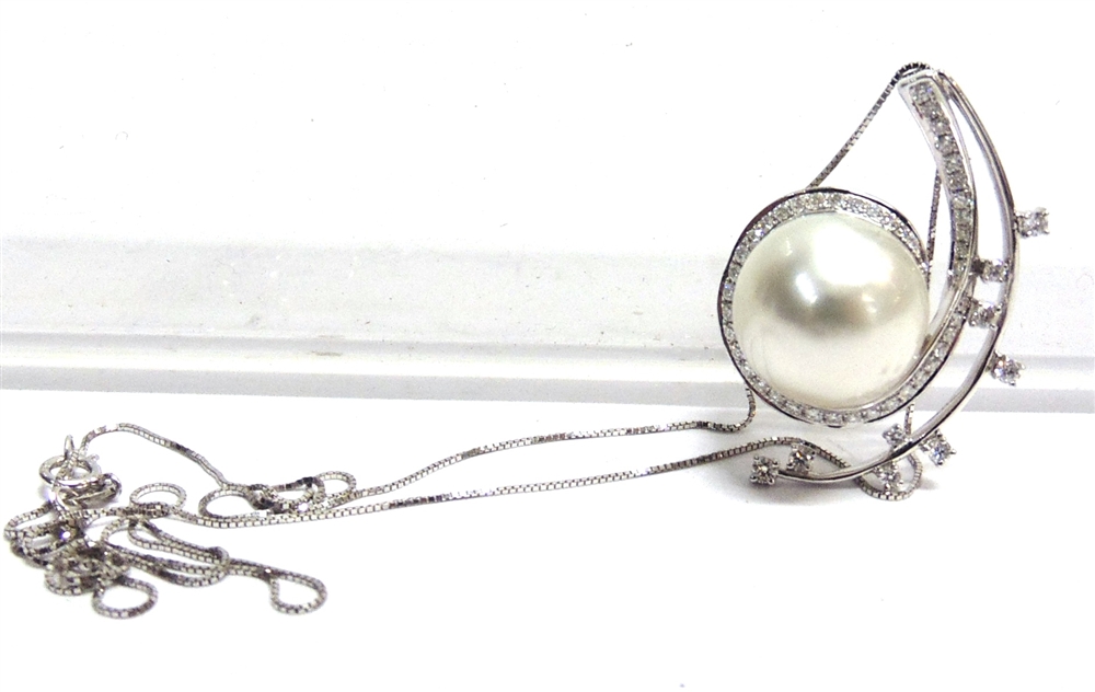 A MODERN CONTINENTAL SOUTH SEA CULTURED PEARL AND DIAMOND PENDANT in the form of an open spiral