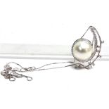 A MODERN CONTINENTAL SOUTH SEA CULTURED PEARL AND DIAMOND PENDANT in the form of an open spiral