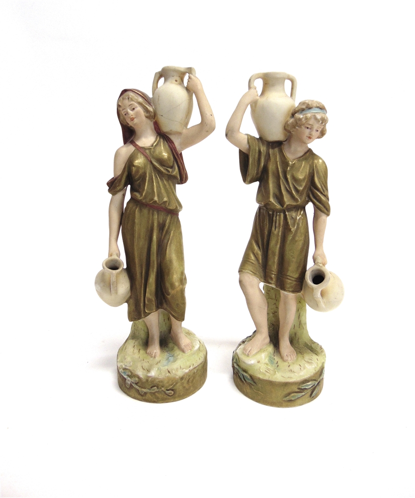 A ROYAL DUX FIGURE OF A WATER CARRIER model 2264, and his female companion model 2265 (damaged),