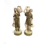 A ROYAL DUX FIGURE OF A WATER CARRIER model 2264, and his female companion model 2265 (damaged),