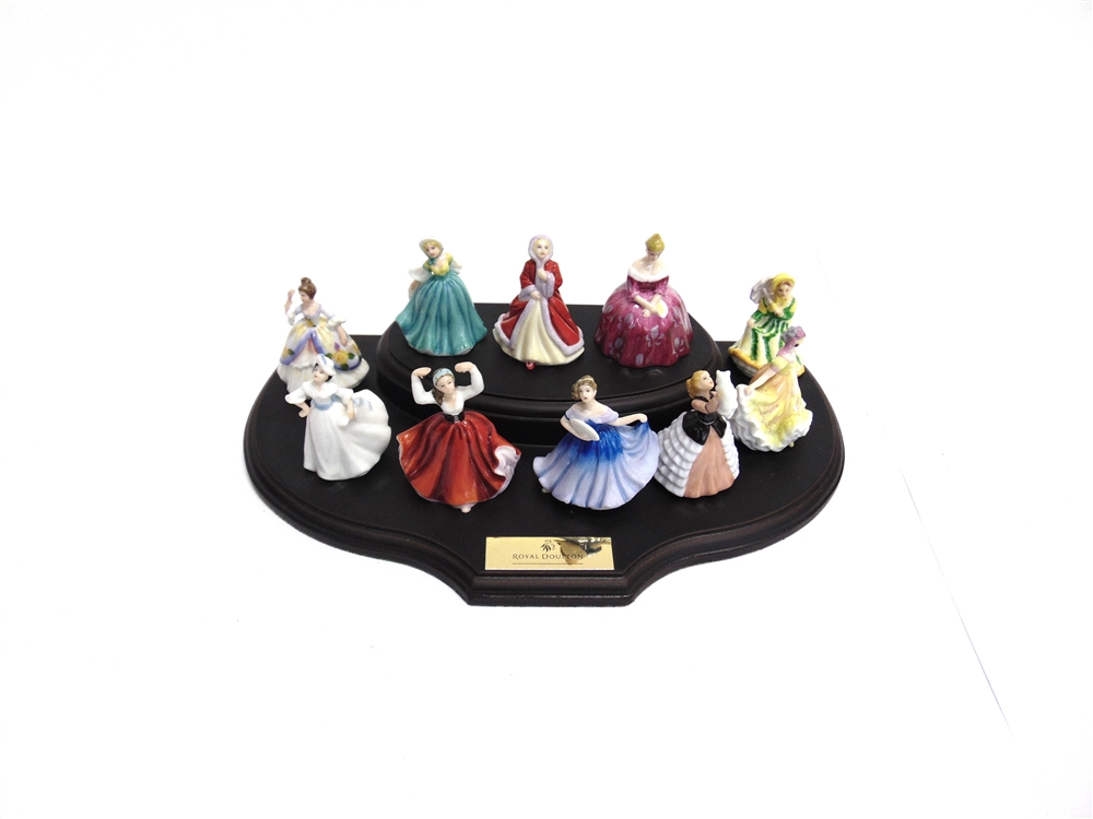 A GROUP OF TEN ROYAL DOULTON MINATURE FIGURINES complete with stand