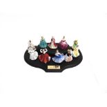 A GROUP OF TEN ROYAL DOULTON MINATURE FIGURINES complete with stand