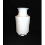 A CHINESE VASE OF ROULEAU FORM with incised floral decoration on a white ground, 30cm high