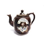 A MEASHAM BARGEWARE TREACLE GLAZE TEAPOT with applied floral decoration, inscribed 'A PRESENT FROM A