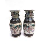 A PAIR OF LARGE CHINESE VASES polychrome enamelled with a procession of figures, moulded dragon