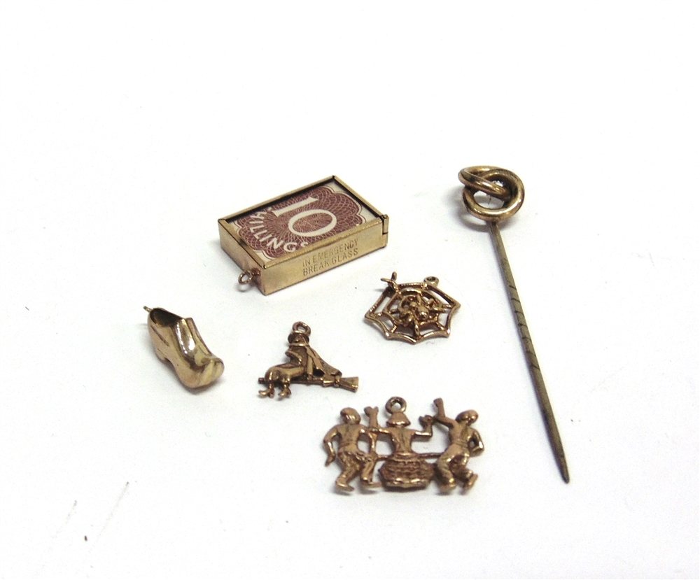 FOUR 9CT GOLD CHARMS comprising; a clog; a witch on a broom; a spider's web; and three dancing