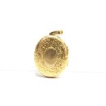 AN EARLY 20TH CENTURY CHINESE EXPORT GOLD OVAL LOCKET engraved with flowers, leaf scrolls and an