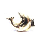 A MODERN CONTINENTAL PENDANT IN THE FORM OF A DOLPHIN in an arched position, the bale stamped '585',