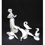 A LLADRO FIGURE OF A YOUNG GIRL with a goose and bowl of corn, and four further Lladro goose