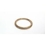 AN EARLY 20TH CENTURY ROSE GOLD HOLLOW PART-FACETTED SLAVE BANGLE Chester 1922, approx. 7.5mm