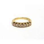 A DIAMOND HALF-ETERNITY RING the seven round brilliants approx. 0.42cts total, claw set to a 'D'