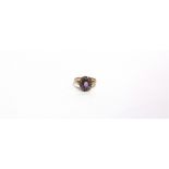 AN EARLY 20TH CENTURY ROSE GOLD, AMETHYST AND DIAMOND OVAL CLUSTER RING centred with an oval mixed-