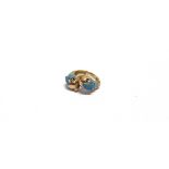 A MODERN CONTINENTAL ENAMELLED CROSS-OVER RING IN THE FORM OF TWO STYLISED DOLPHINS each with