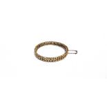 AN EARLY 20TH CENTURY GOLD HOLLOW DOUBLE-CURB LINK HINGED BANGLE On a push snap, stamped '15',