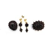 A SMALL GROUP OF BOHEMIAN GARNET JEWELLERY comprising; a shaped-oval tiered cluster brooch 32mm wide