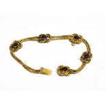 A LATE VICTORIAN GOLD AND AMETHYST BRACELET in the form of two rows of cable link chains with five