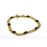 A MODERN CABOCHON SAPPHIRE CURB BRACELET the seven oval cabochons each rub-over set on a filed