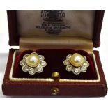 A PAIR OF CULTURED PEARL AND DIAMOND FLOWER-HEAD CLUSTER STUD EARRINGS each centred with a light-