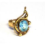 A 9CT GOLD AND PALE BLUE TOPAZ ABSTRACT WIREWORK AND BEAD RING the oval mixed-cut stone rub-over set