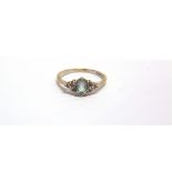 AN 18CT WHITE GOLD, AQUAMARINE AND DIAMOND DRESS RING centred with an oval mixed-cut pale-blue