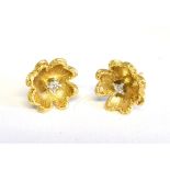 A PAIR OF 18CT GOLD AND SMALL DIAMOND ABSTRACT FLOWER-HEAD STUD EARRINGS each claw set in white at