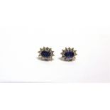 A PAIR OF 18CT WHITE GOLD, SAPPHIRE AND DIAMOND OVAL CLUSTER STUD EARRINGS each centred with an oval