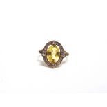 AN EARLY 20TH CENTURY GOLD, YELLOW SAPPHIRE AND DIAMOND OVAL CLUSTER RING centred with an oval