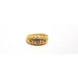 AN EARLY 20TH CENTURY 18CT GOLD, SAPPHIRE AND DIAMOND GYPSY RING centred with a small pale-blue