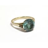 A MID 20TH CENTURY GOLD, BLUE ZIRCON AND DIAMOND RING centred with a round zircon-cut pale-blue