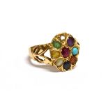 A MODERN MULTI-GEM OVAL CLUSTER RING the head centred with an oval mixed-cut ruby within an eight