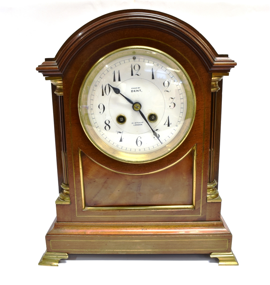 AN EDWARDIAN BRASS MOUNTED MAHOGANY MANTLE CLOCK the 8-day movement striking on a coiled gong, the