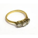 AN EARLY TO MID 20TH CENTURY GOLD AND DIAMOND THREE STONE RING the graduated early modern round