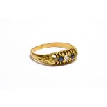 AN EARLY 20TH CENTURY GOLD, SAPPHIRE AND DIAMOND FIVE STONE RING the three graduated old-cut and