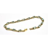 A MODERN 9CT GOLD AND PALE BLUE TOPAZ BRACLET The 15 oval mixed-cut stones claw set with oval