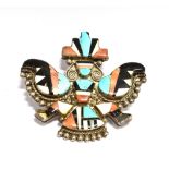 AN AMERICAN SOUTH WEST ZUNI SILVER AND INTARSIA BROOCH in the form of a stylised bird or Kachina