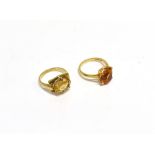 TWO MODERN 9CT GOLD AND OVAL CITRINE SINGLE STONE RINGS comprising; one set with a pale yellow