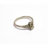 AN EARLY 20TH CENTURY PLATINUM AND DIAMOND TWO STONE RING with diamond shoulders, the two