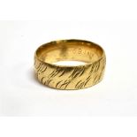 A 9CT GOLD BROAD WEDDING BAND engraved with diagonal meandering scrolls, Sheffield 1994 by Brown &