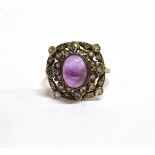 AN AMETHYST AND DIAMOND ROUNDED-SQUARE CLUSTER RING IN ART DECO STYLE rub-over set at the centre