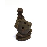 AN AFRICAN TERRACOTTA TRIBAL FIGURE modelled as a seated female, holding a large ball, possibly a