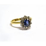 A MODERN 18CT GOLD, SAPPHIRE AND DIAMOND OVAL CLUSTER RING centred with an oval mixed-cut